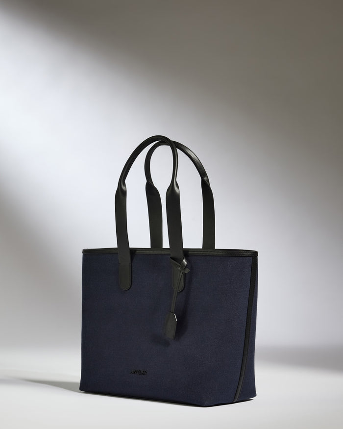 a blue bag with black handles