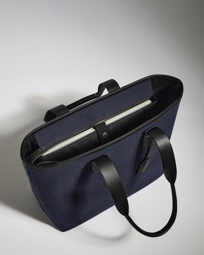 a blue bag with a black strap