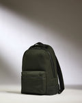 a black backpack on a white surface