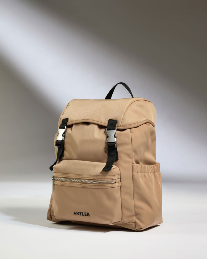 a tan backpack with black straps