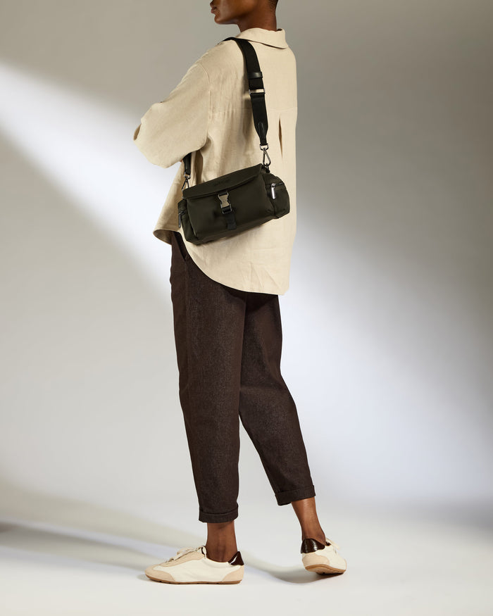 a woman with a bag over her shoulder
