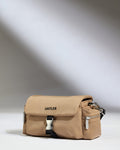 a tan bag with black straps