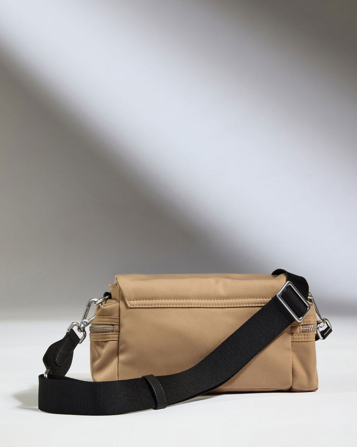 a tan bag with a black strap