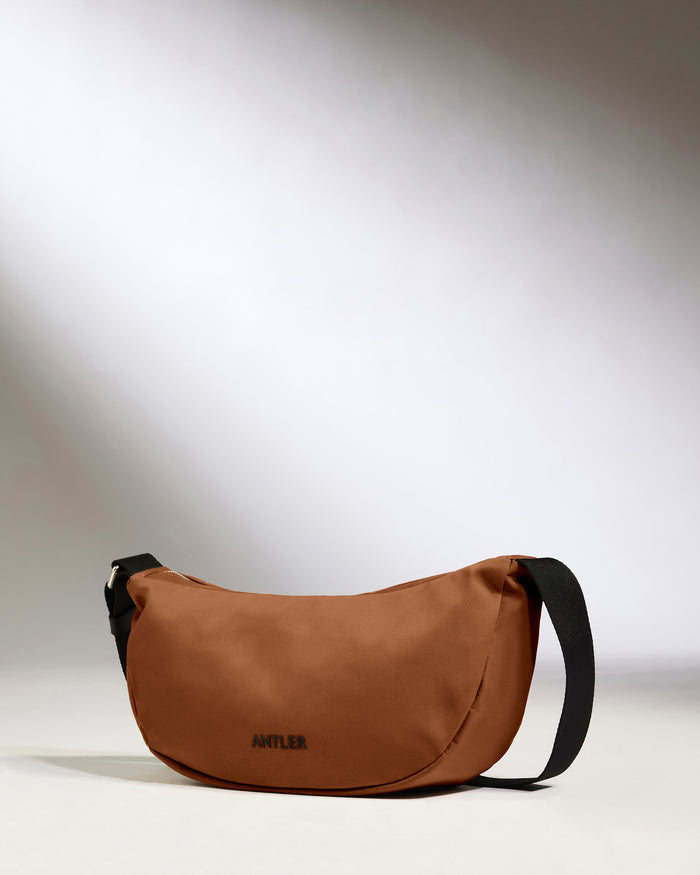 a brown bag with a black strap