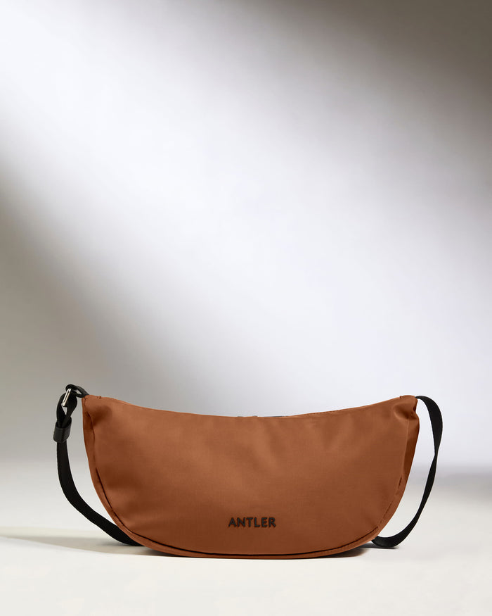 a brown bag with black straps