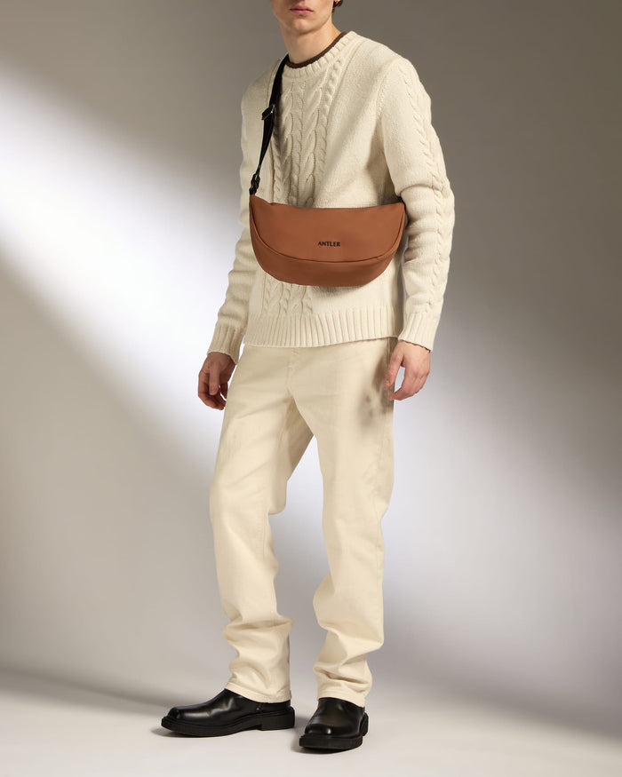 a man in a white sweater and white pants
