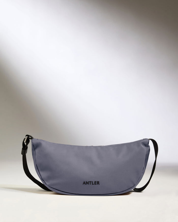 a grey bag with black straps