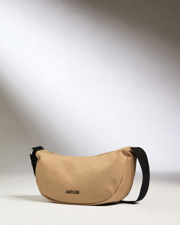 a tan bag with black strap