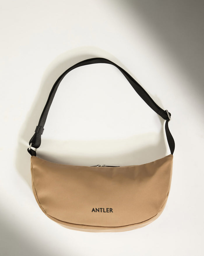 a tan bag with black straps