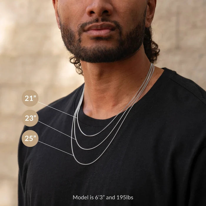 Man wearing a necklace with measurements indicated on a neutral background