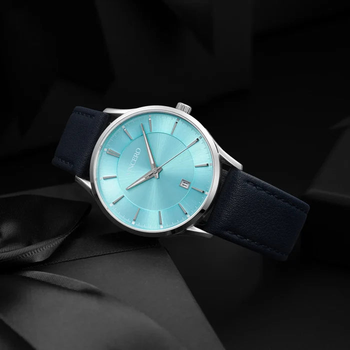 Watch with blue face and dark blue strap on a black background