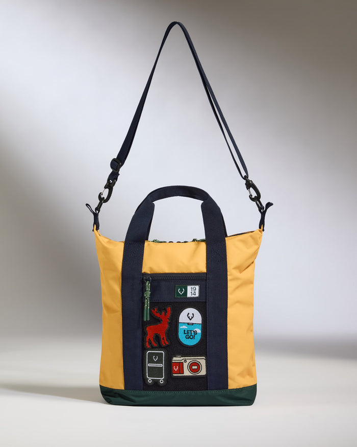 a yellow and black bag with a patchwork design