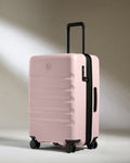 a pink suitcase with wheels