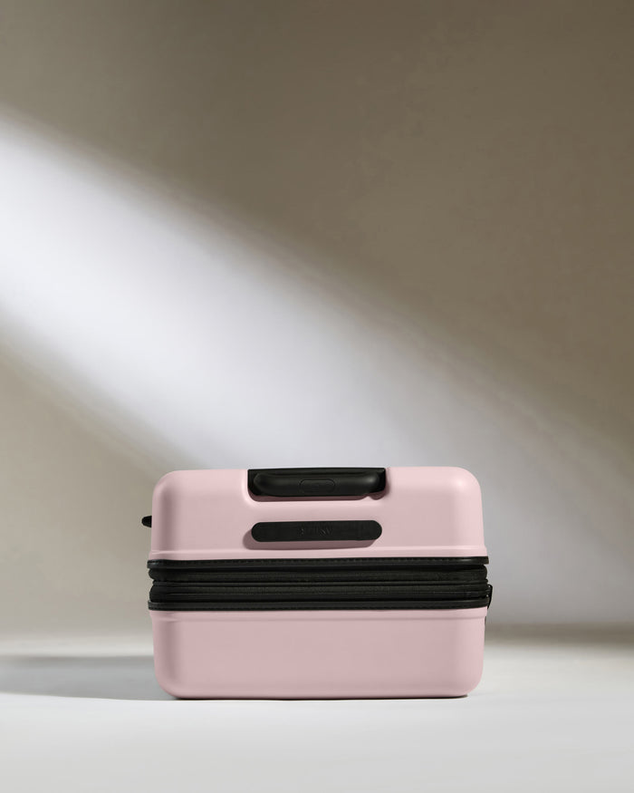 a pink suitcase with a black zipper