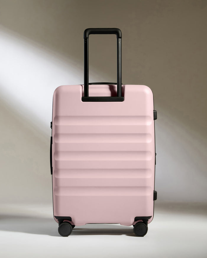 a pink suitcase with wheels