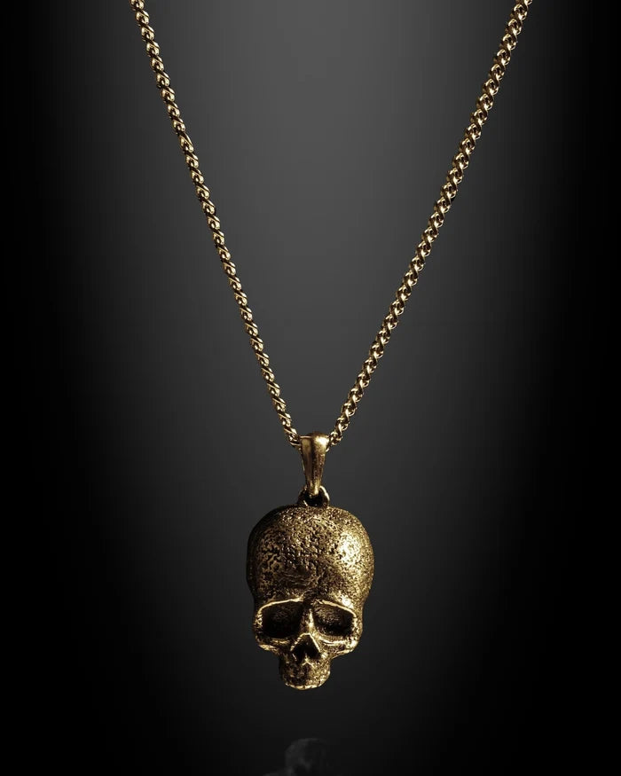 Gold chain necklace with a skull pendant