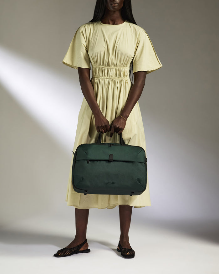 a woman in a dress holding a bag