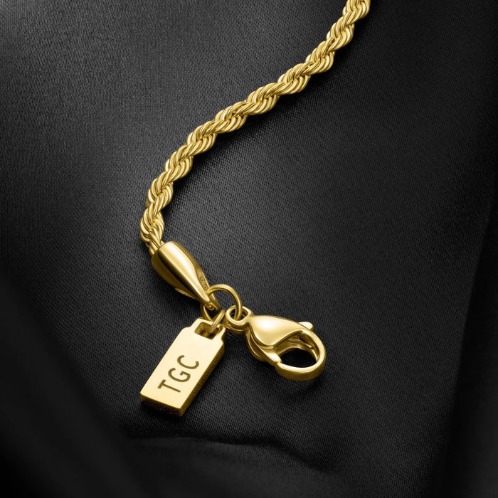 Gold rope chain bracelet with a clasp and 'TGC' tag on a black background