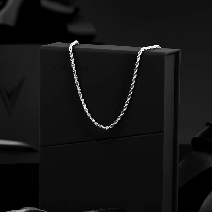 Silver chain on a black box with 'Vincero' branding against a dark background