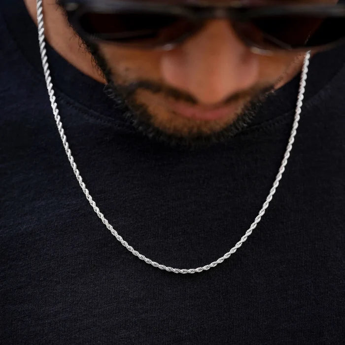 Close-up of a silver chain necklace on a dark background