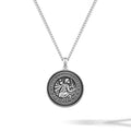 Silver necklace with a round pendant on a white background