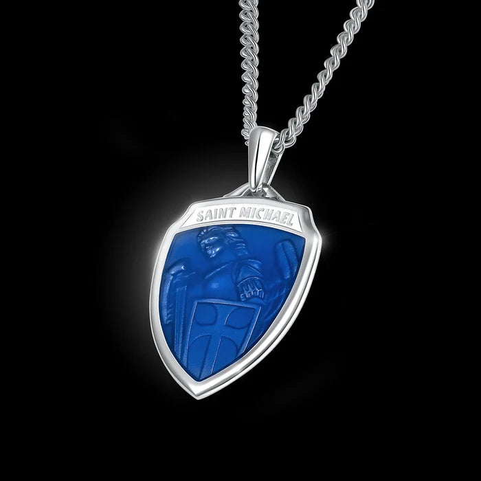 Silver pendant with blue emblem and 'Saint Michael' engraving on a black background