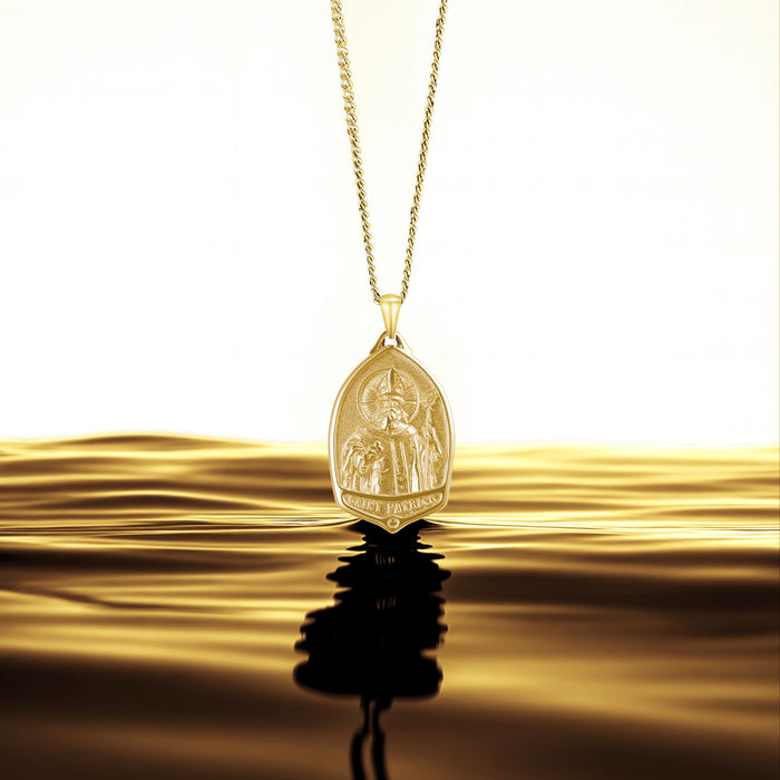 Gold pendant necklace with a reflective surface