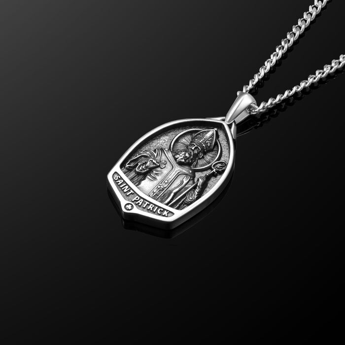 Silver pendant with 'Saint Patrick' engraving on a black background