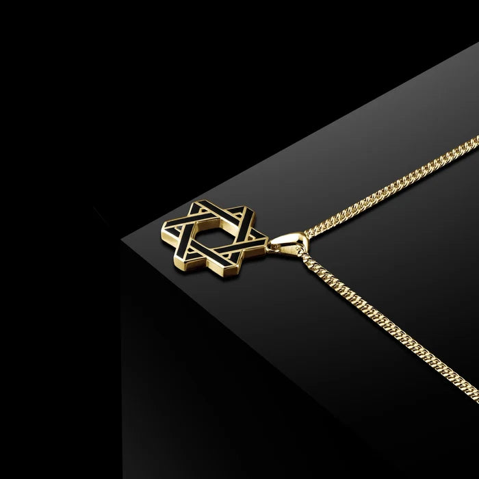 Gold chain necklace with a Star of David pendant on a dark background