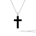 Black cross pendant on a silver chain against a white background