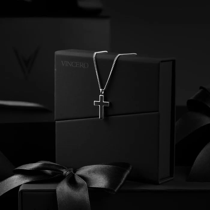 Black cross pendant on a silver chain