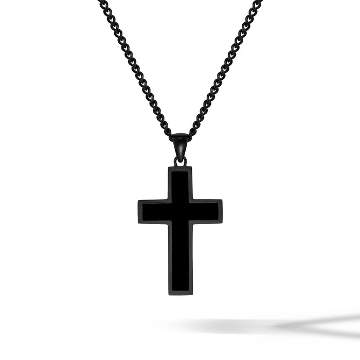 Black cross pendant on a chain against a white background
