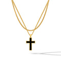 A gold-plated cross pendant on a two-layer gold box chain necklace against a white background.