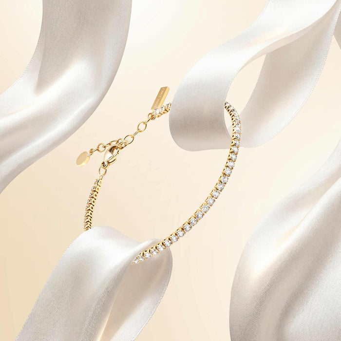 Gold necklace on a mannequin with a soft beige background