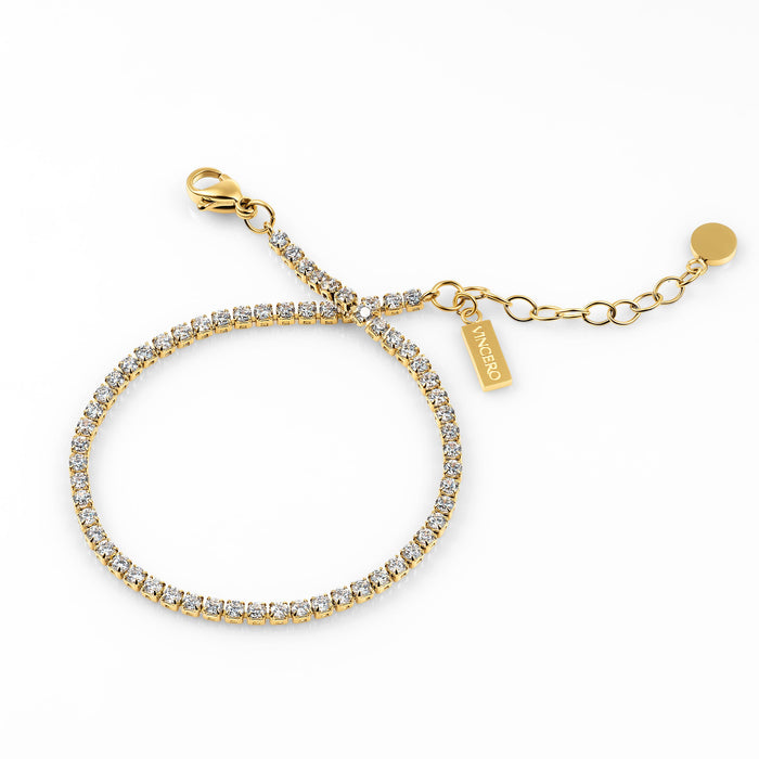Gold bracelet with clear stones on a white background