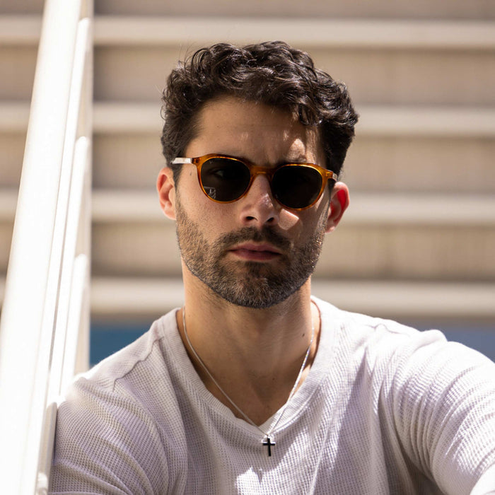 Man wearing sunglasses with a neutral background