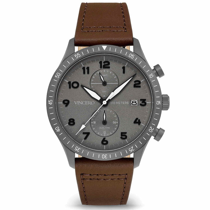 A gunmetal watch with a walnut brown leather strap and a matte black dial featuring luminous hands and indices.