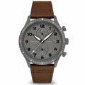 A gunmetal watch with a walnut brown leather strap and a matte black dial featuring luminous hands and indices.