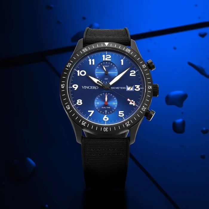 Black wristwatch with blue dial on a dark blue background