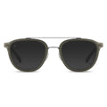 A pair of round full frame sunglasses with a metal bridge and acetate temples, in a gray color.