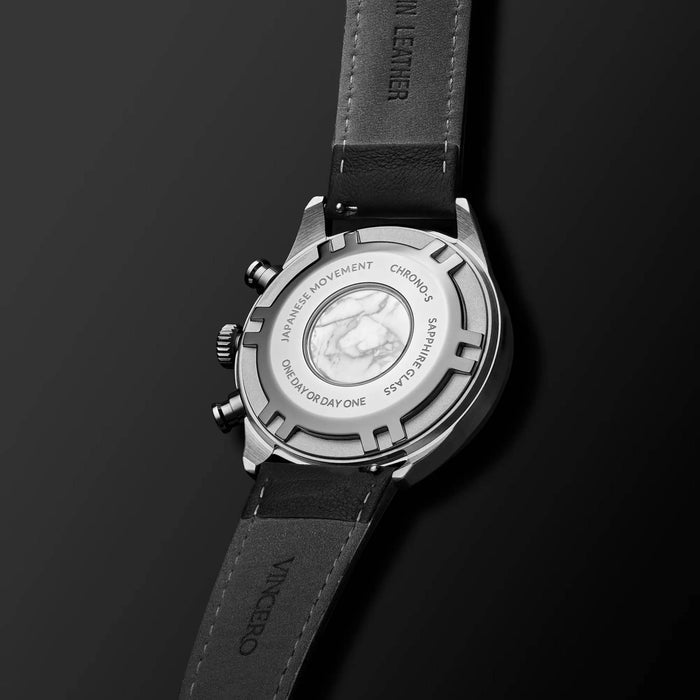 Black wristwatch with silver case on a black background