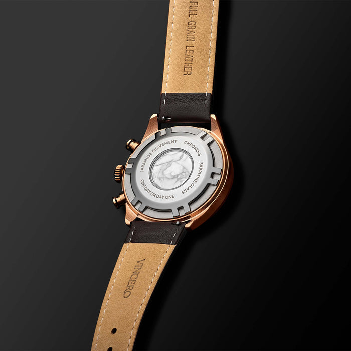 Watch with brown leather strap and rose gold case on a black background