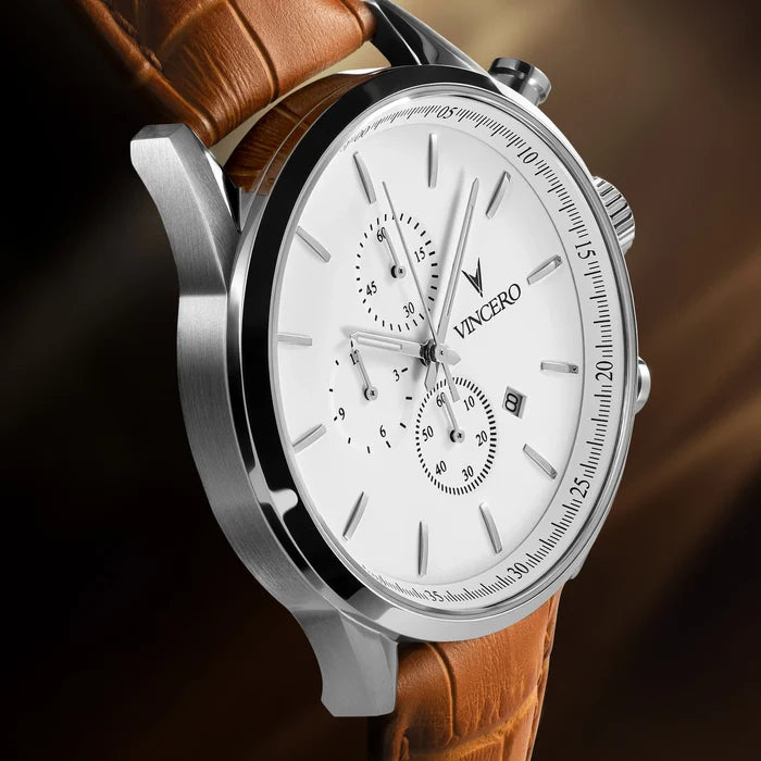 Watch with brown leather strap and silver case on a dark background