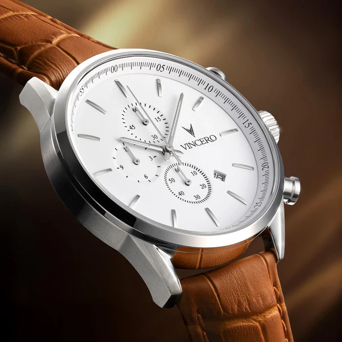 Silver wristwatch with a brown leather strap on a gradient background