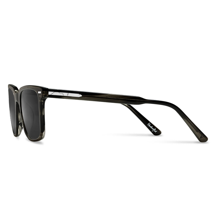 Sunglasses with black frame and dark lenses on a white background
