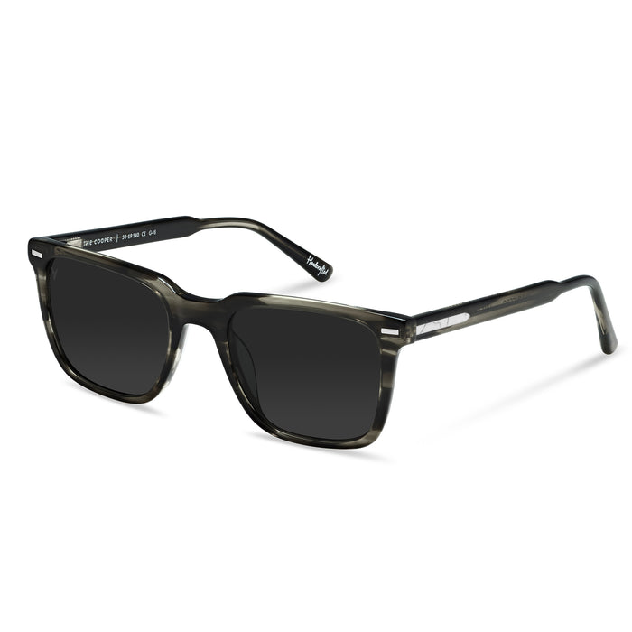 Sunglasses with dark lenses and a transparent frame on a white background