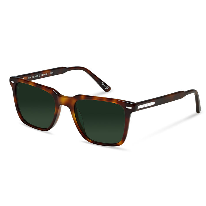 Sunglasses with tortoiseshell frame and dark lenses on a white background