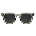 A pair of square-shaped, stone-colored sunglasses with a sleek and modern design, featuring polarized lenses and a brown acetate frame.
