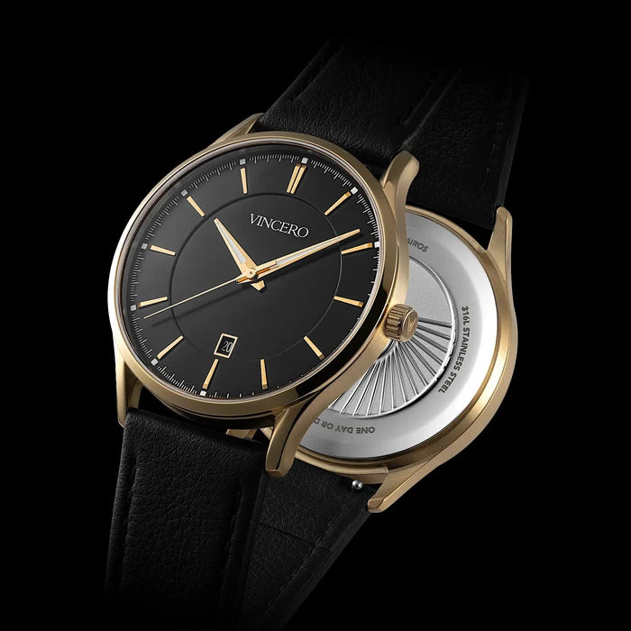 Luxury watch with black dial and gold case on a black background