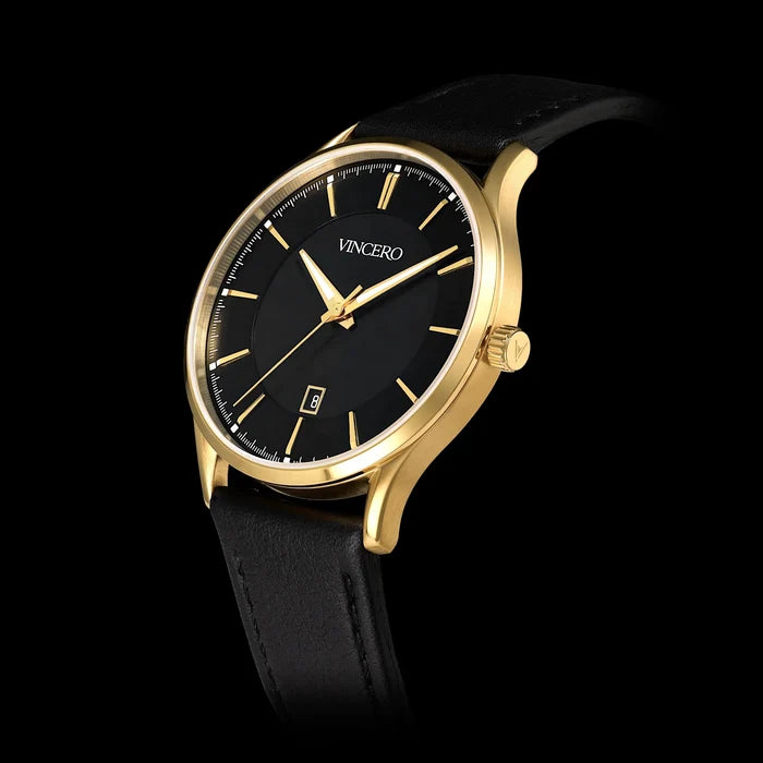 Gold wristwatch with black face and leather strap on a black background